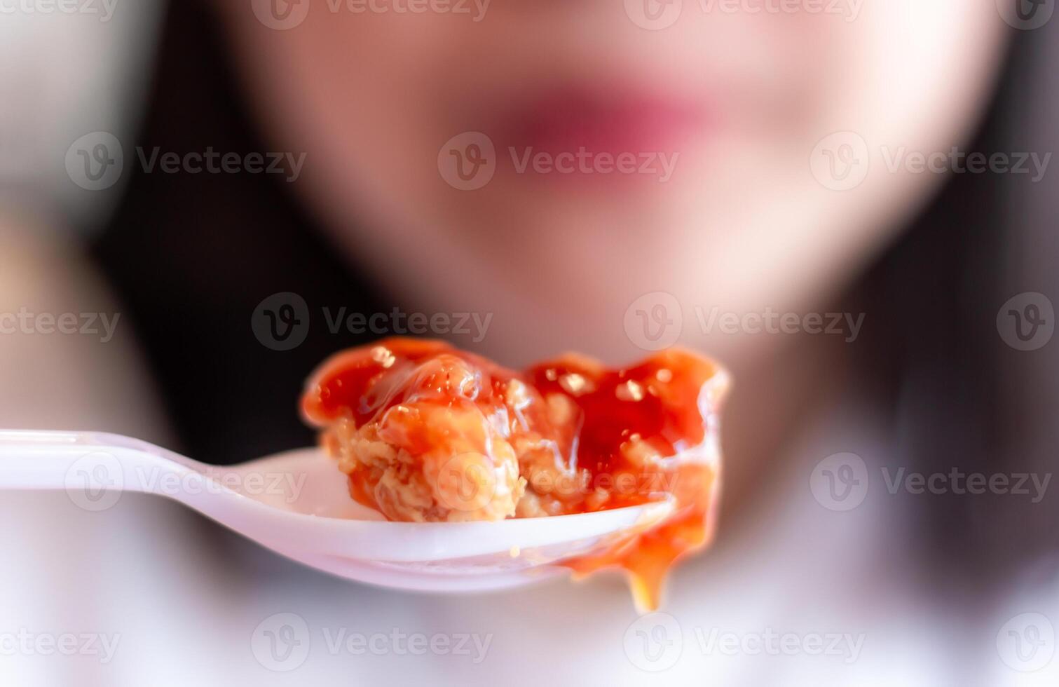 Woman eating fried chicken blurred background photo