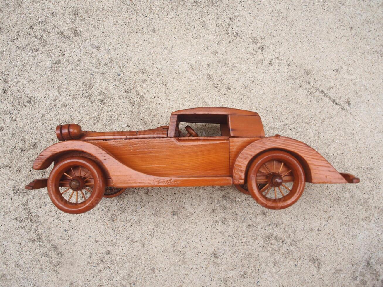 Wooden toy car. Isolated on white background. Slightly de-focused and close-up shot. Copy space. photo