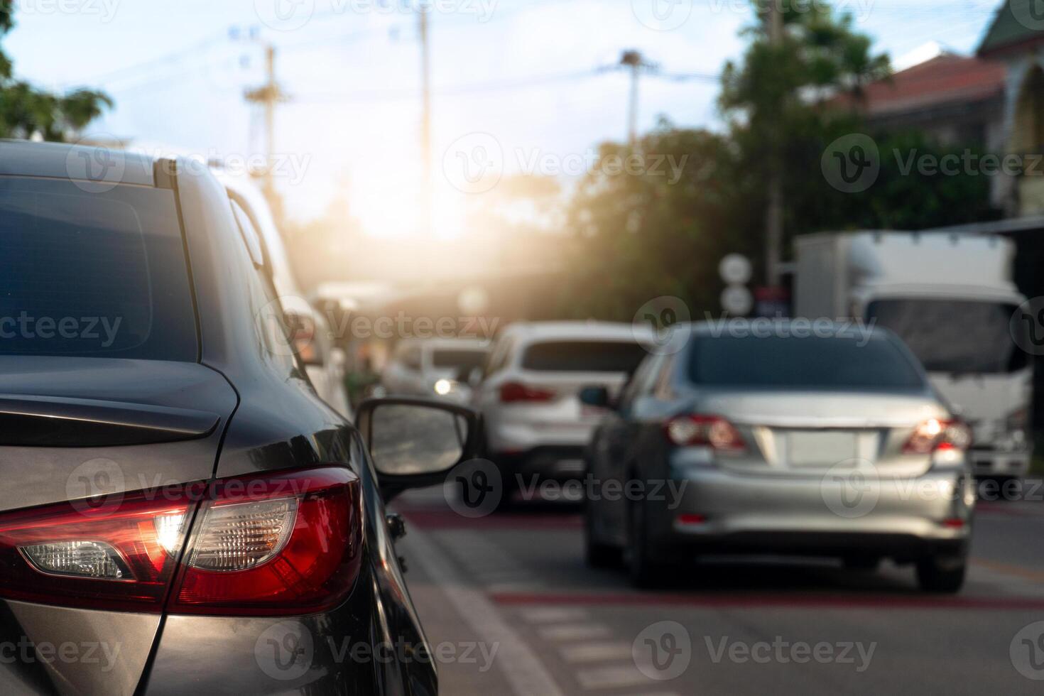 Luxury of dark car stop on the asphalt road. Traveling in the provinces during the bright period. Traffic with many car in the city. photo