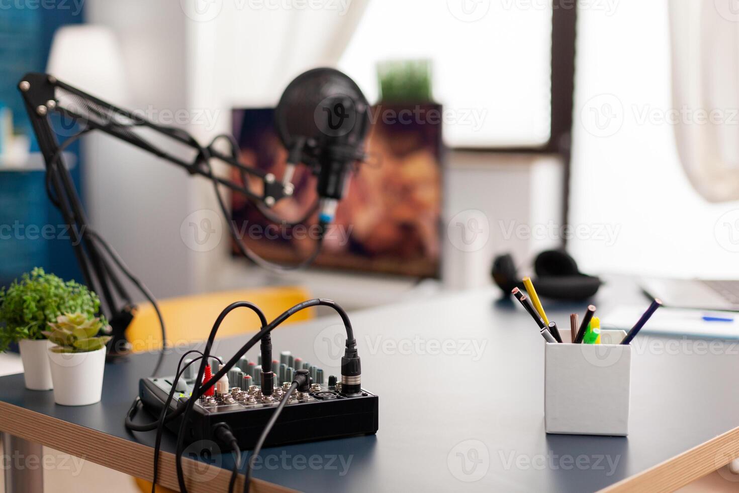 Microphone and mixer for podcast of famous creator. Influencer recording social media content with production microphone in professional home studio with modern equipment photo
