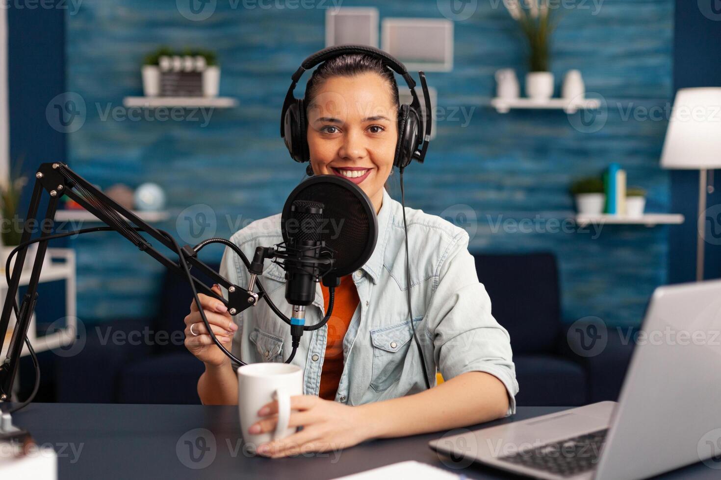 Influencer wearing headphones recording new podcast series at home studio for youtube channel. On-air online production internet broadcast show host streaming live social media content photo