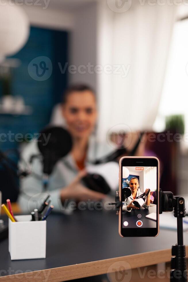 Creative vlogger and influencer filming a vr headphones review in professional studio podcast. Social media in digital internet web era recording new for online audience photo