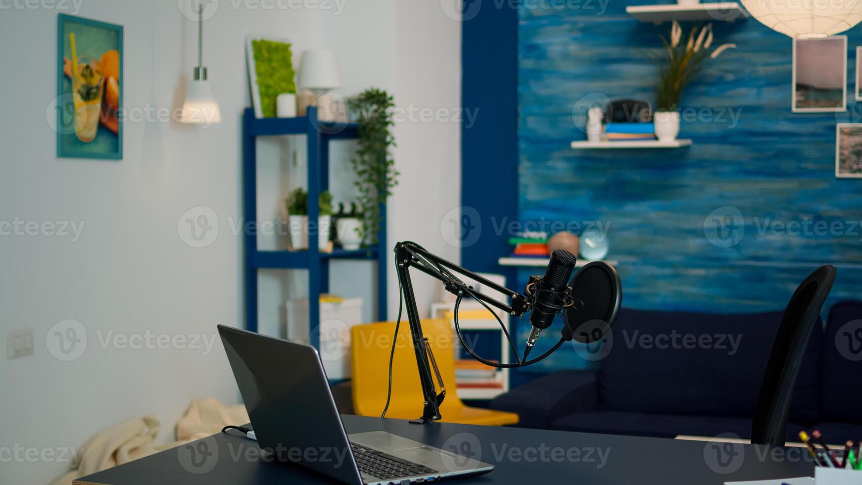 Professional podcast microphone and laptop for livestream of famous influencer in empty living room. Recording social media content with production technology, digital web internet streaming station photo
