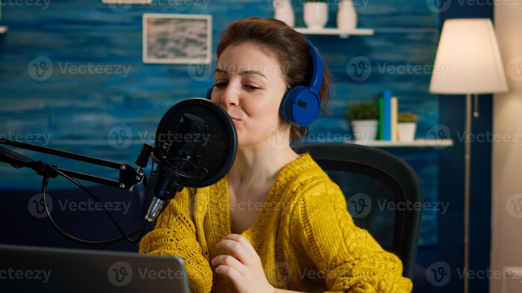 Famous blogger streaming from home studio putting headphones recording vlog. On-air online production internet broadcast show host streaming live content record digital social media communication photo