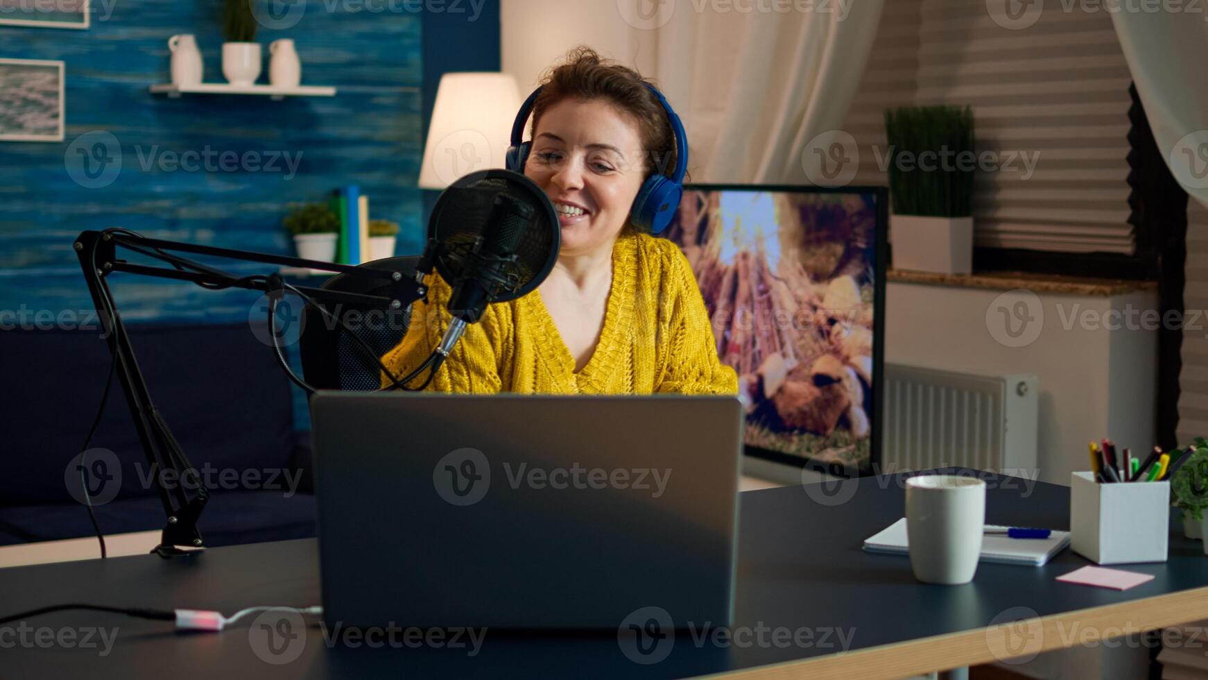 Influencer wearing headphones recording new podcast series for audience. On-air online production internet broadcast show host streaming live content for digital social media using internet web photo
