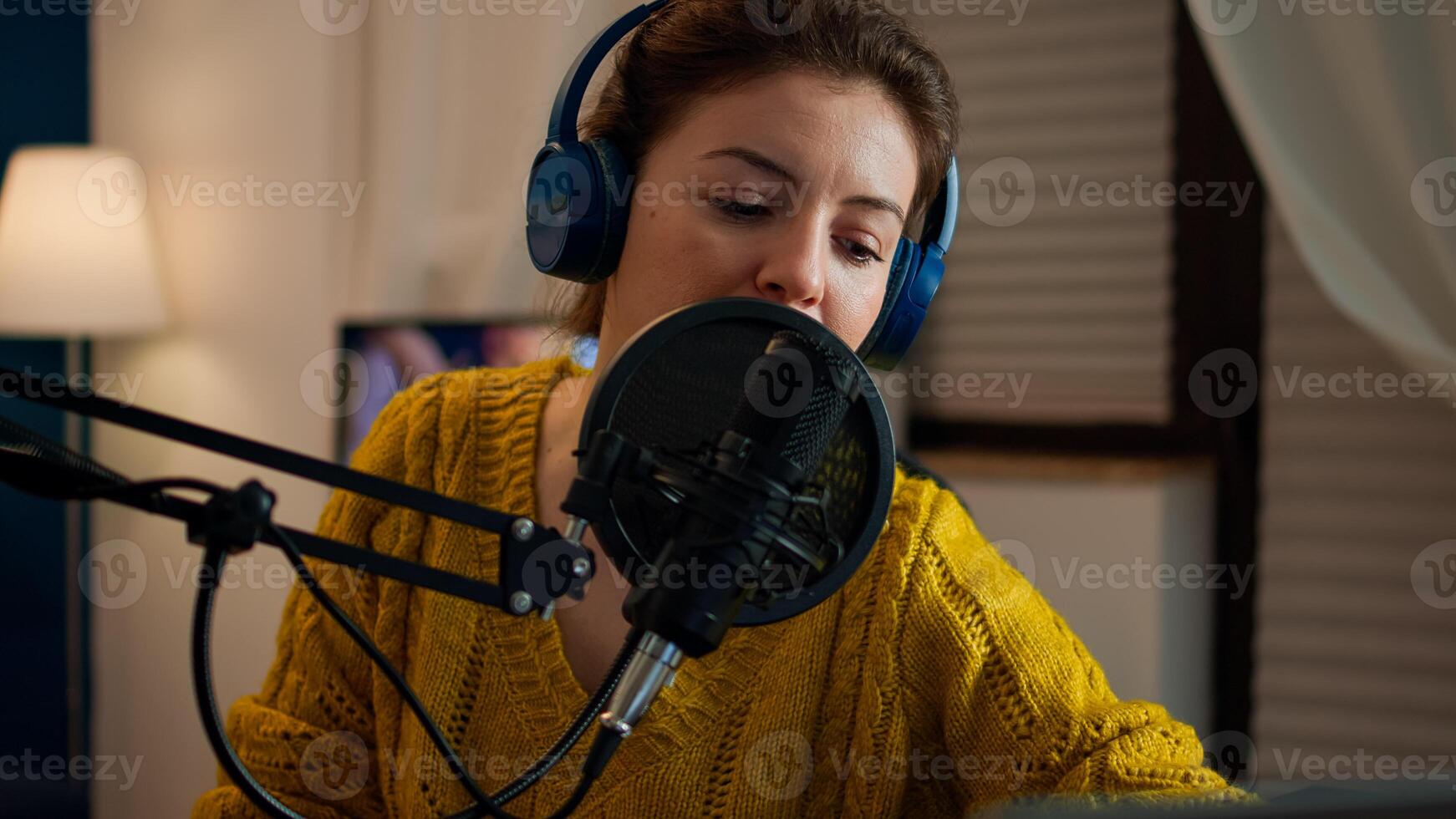 Creative blogger wearing headphones checking sound before talking with fans during live on social media, podcasting. On-air online production internet broadcast show host streaming live content photo