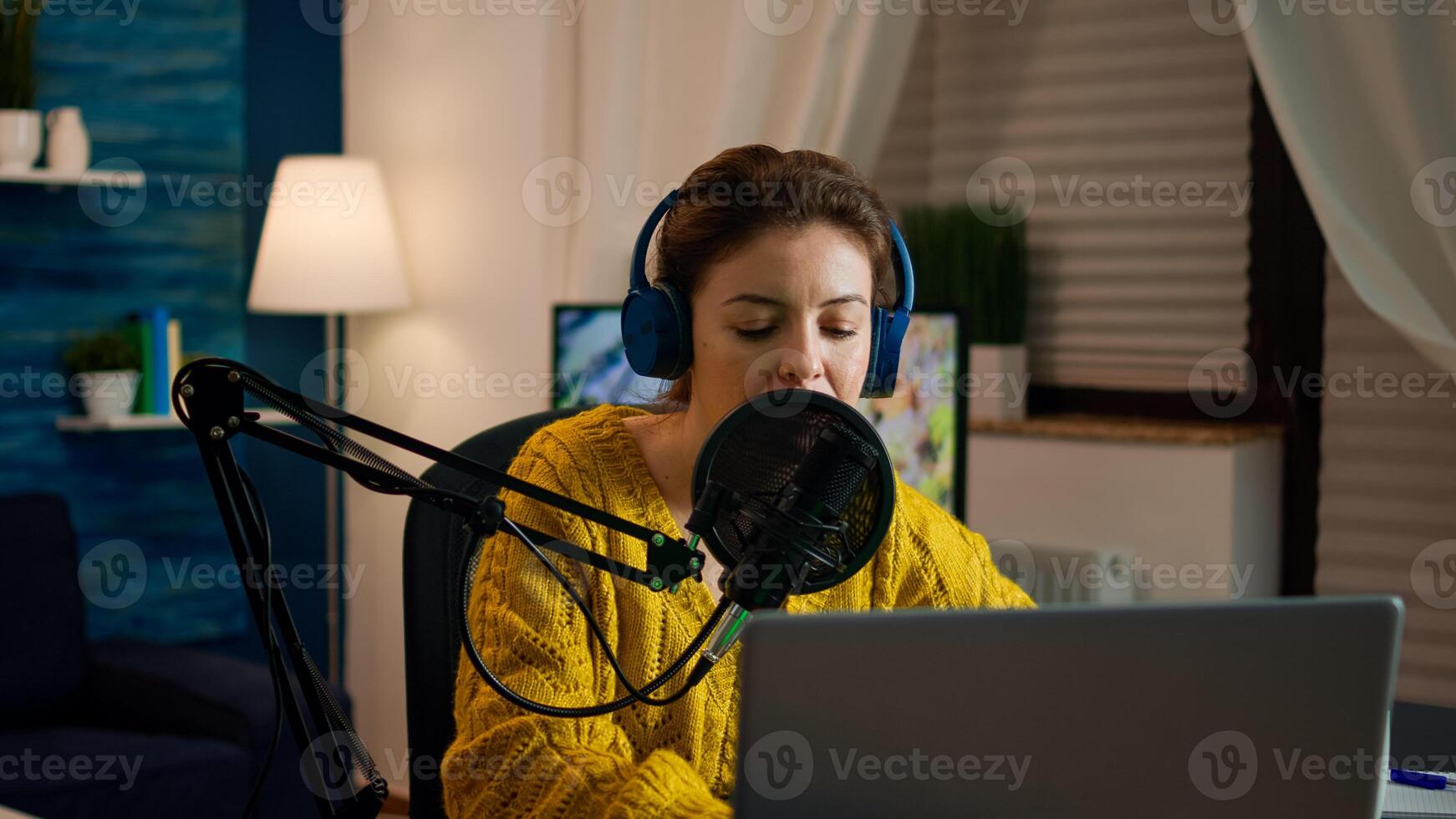 Social media influencer opening laptop starting to record new podcast from home studio. On-air online production internet broadcast show host streaming live content, recording digital vlog photo