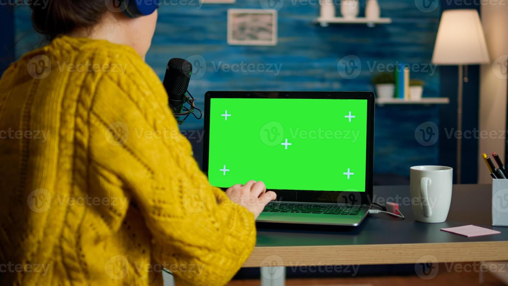 blogger reading emails on laptop with green screen display during broadcast. Creative online show On-air production internet broadcast host streaming live content using chroma key laptop photo