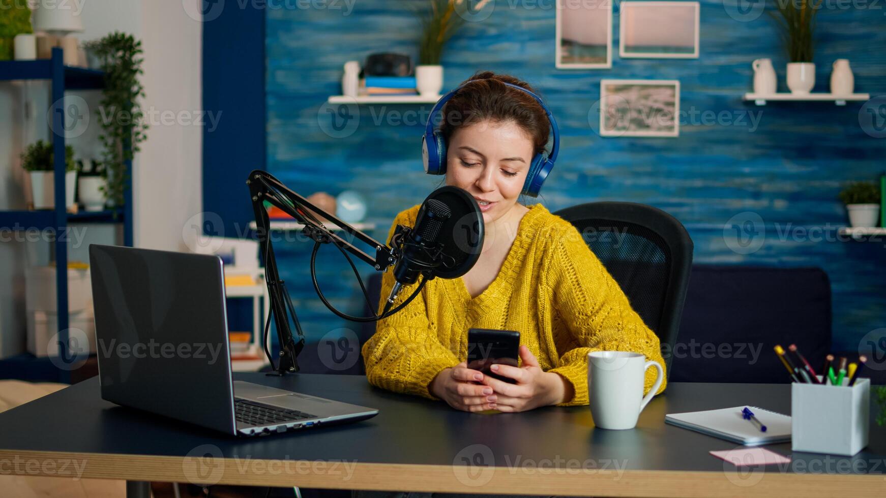 Influencer using laptop while talking with followers during live on social media. Creative online show On-air production internet broadcast host streaming live content, recording digital vlog photo