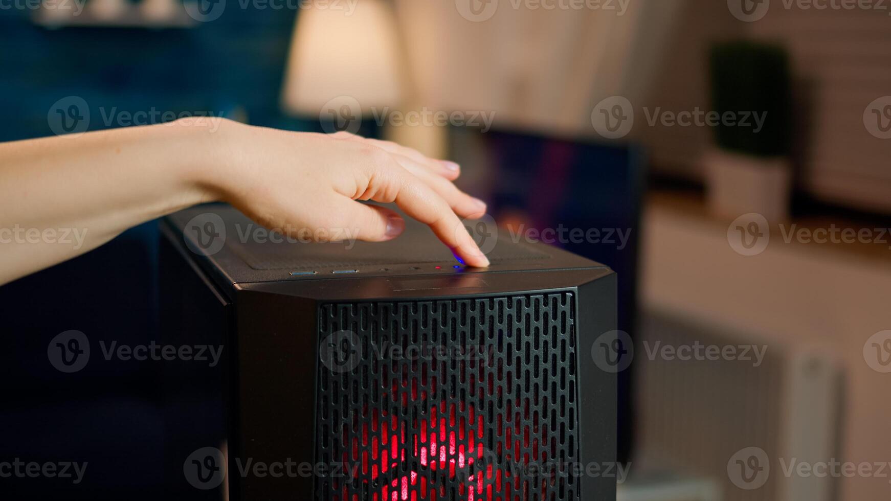 Professional esports gamer operating pc system, pressing on start button of computer unit. Woman preparing for gaming tournament, cyber performing in stylish room playing online shooter game photo