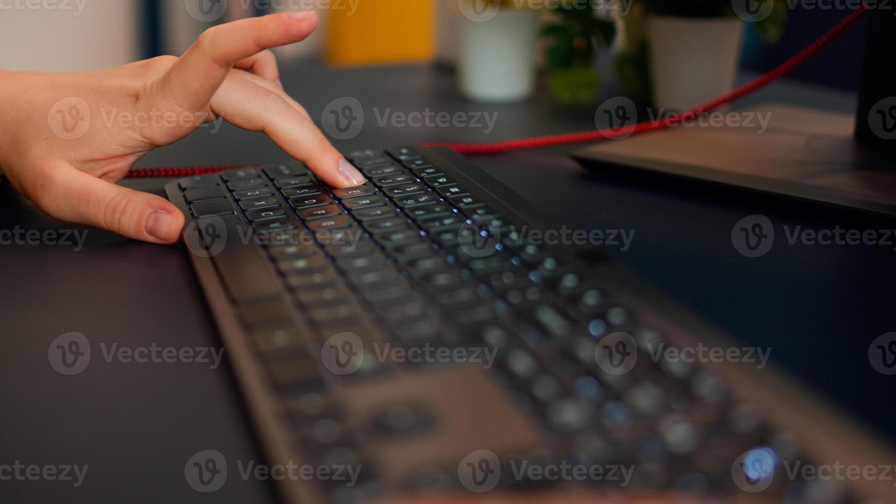 Close-up on hands of woman gamer playing game using RGB keyboard. Virtual championship in cyberspace, esports player performing on pc during gaming tournament using technology network wireless photo