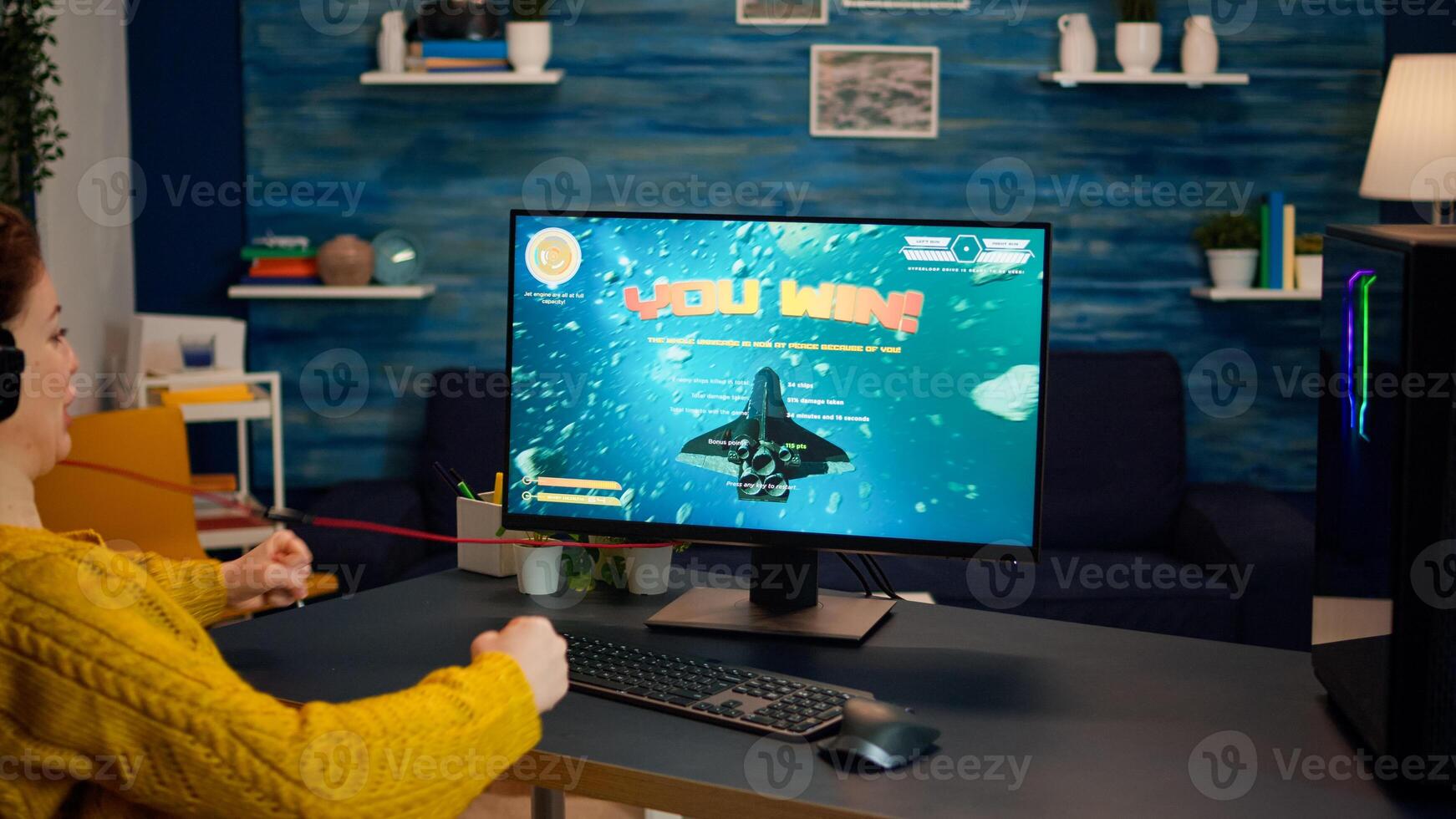 Professional esports gamer playing on computer game, happily and cheerfully celebrates victory and success. Online cyber gaming tournament live streaming event using technology network wireless photo