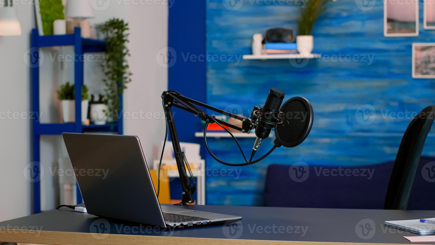 Online live podcast studio desk with microphone in home studio of vlogger. Influencer recording social media content with production microphone. Digital web internet streaming station photo