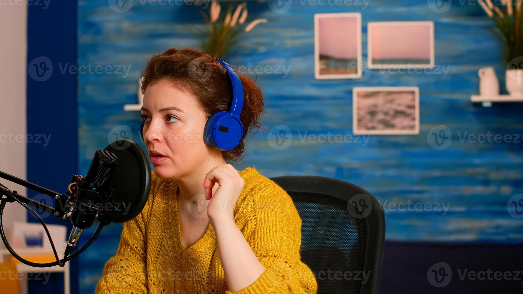 Vlogger checking microphone sound with finger, starting livestreaming sitting in home podcast studio. On-air online production internet broadcast show host streaming live content for social media photo