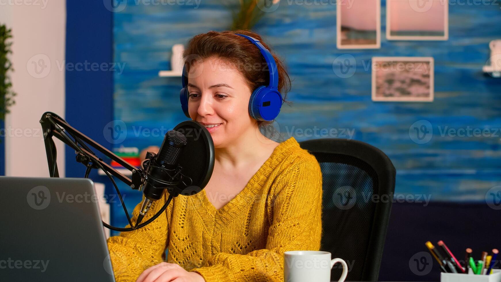 Influencer vlogger looking at laptop while asking audience to subscribe on channel. Creative online show On-air production internet broadcast host streaming live content recording digital social media photo