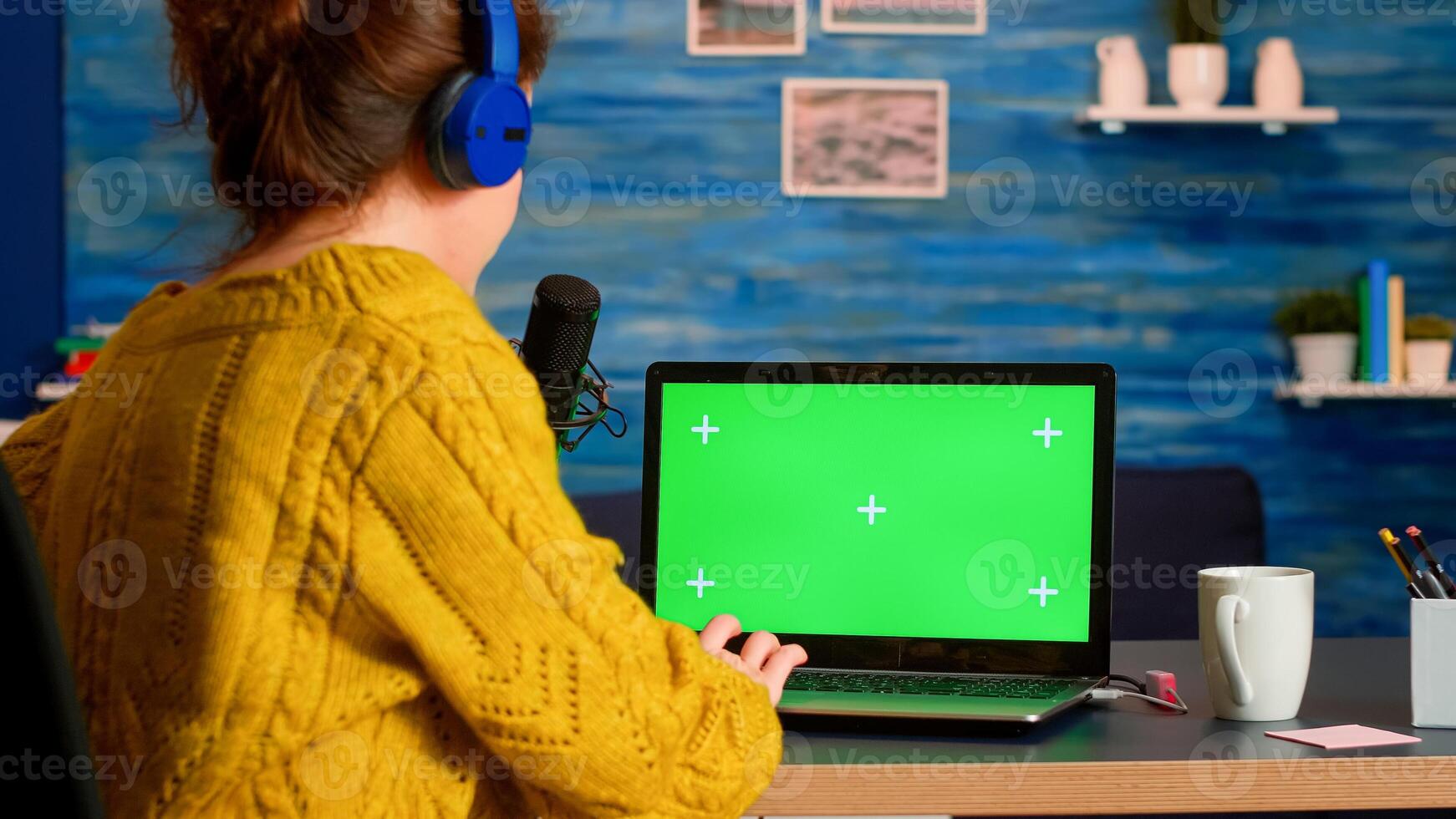 Blogger typing at laptop with green screen display recording new podcast series for audience. Broadcast show host streaming live content for social media using mochup, chroma key, izolated desktop photo