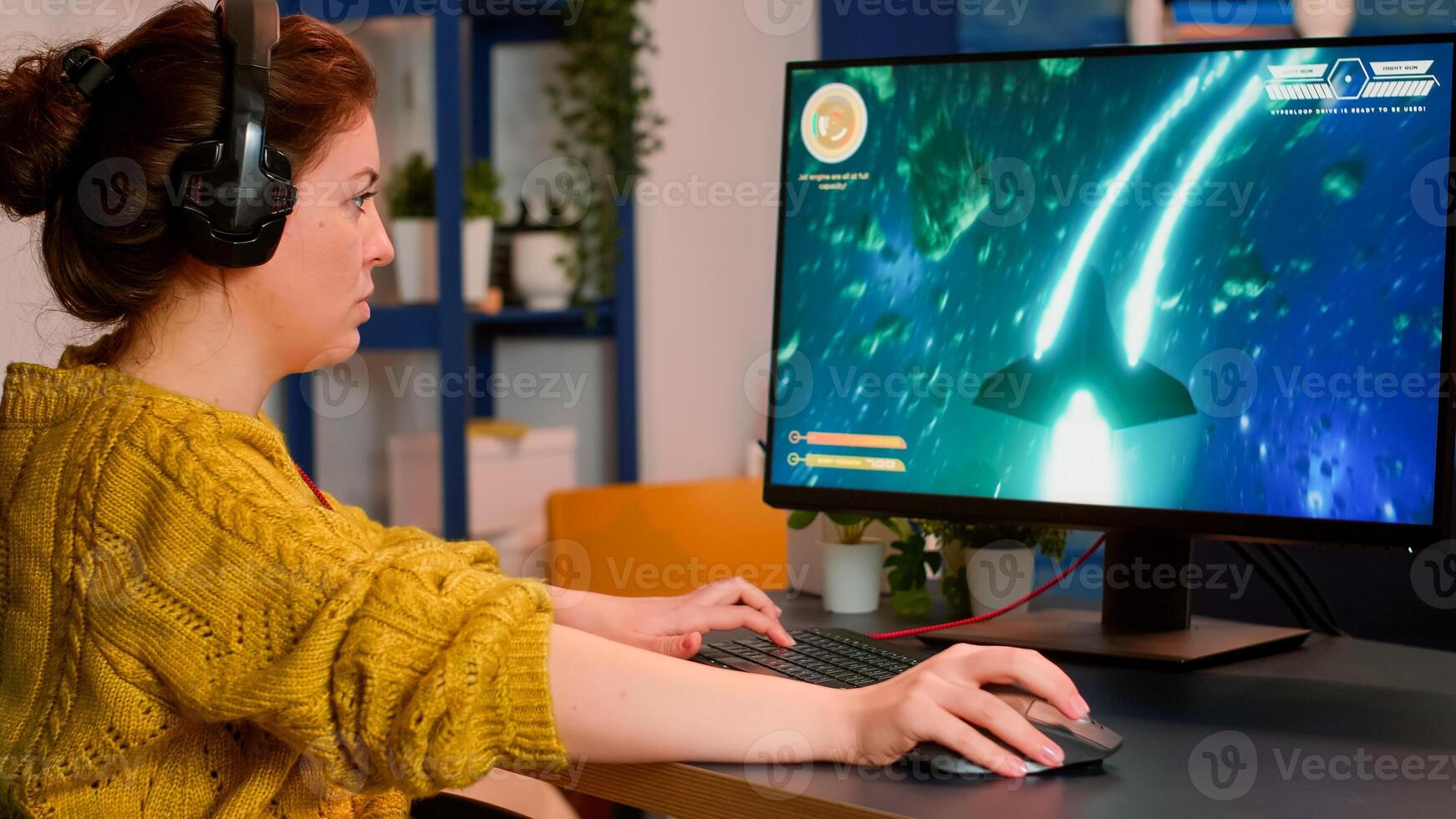 Focused professional woman player wearing headset playing space shooter game on powerful pc. Online streaming cyber performing on powerful personal computer during gaming tournament photo