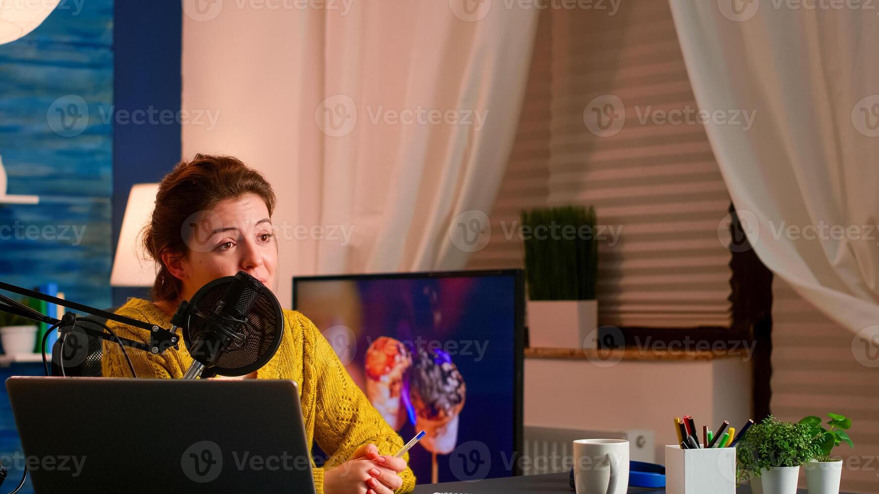 Influence vlogger talking and smiling during live streaming, broadcast with internet subscribers. Social media people , content maker, e-commerce concept. working from home podcast studio. photo