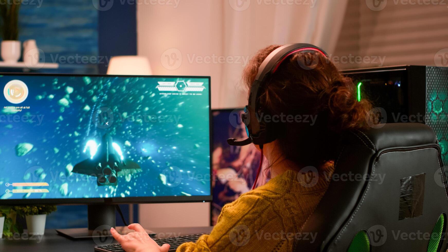 Joyful player celebrates victory winning space shooter online game on powerful personal computer. Online streaming cyber performing during gaming tournament using technology network wireless photo