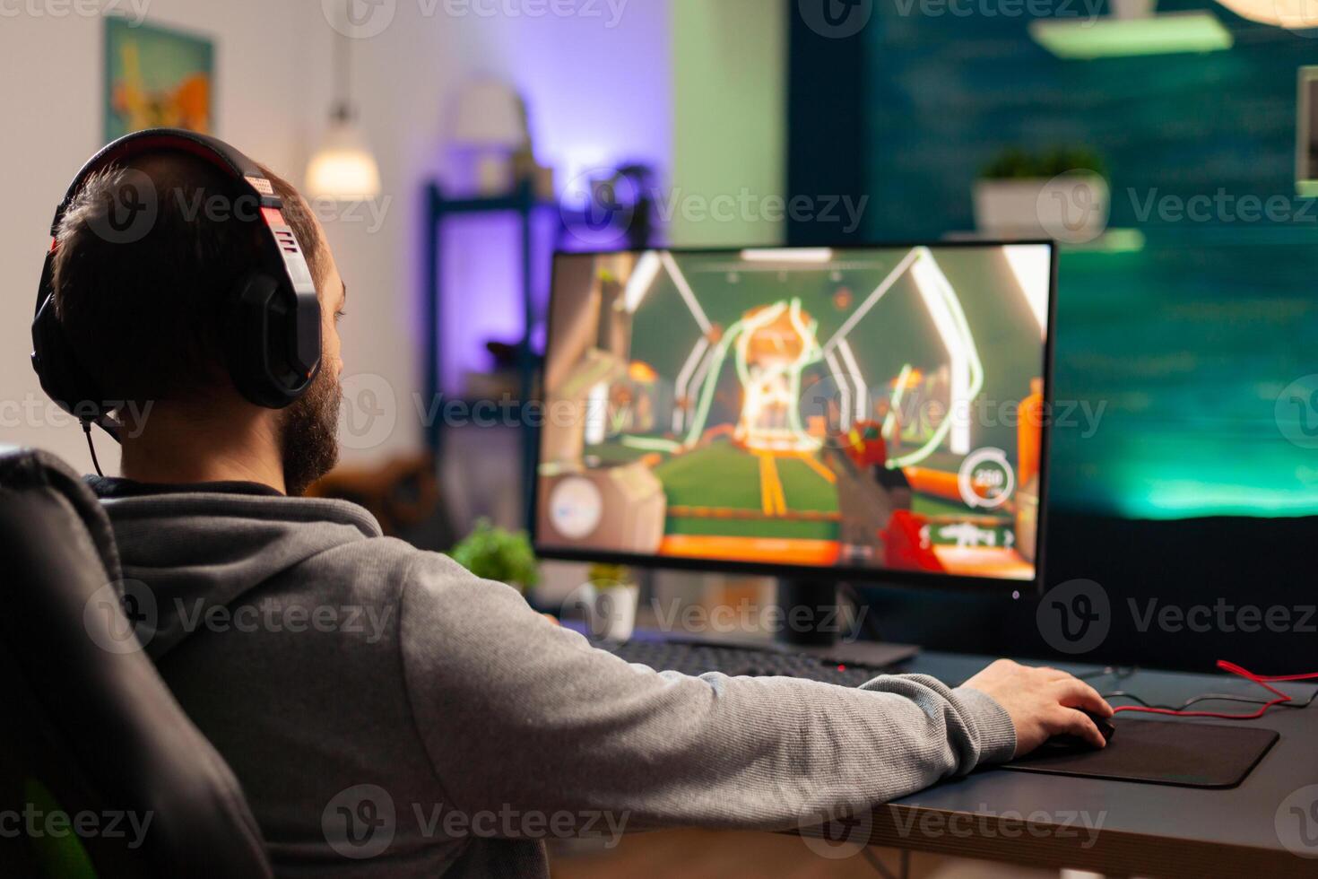 Professional player with headset playing videogame with modern graphics for shooter competition. Online streaming cyber performing during gaming tournament using technology network wireless photo