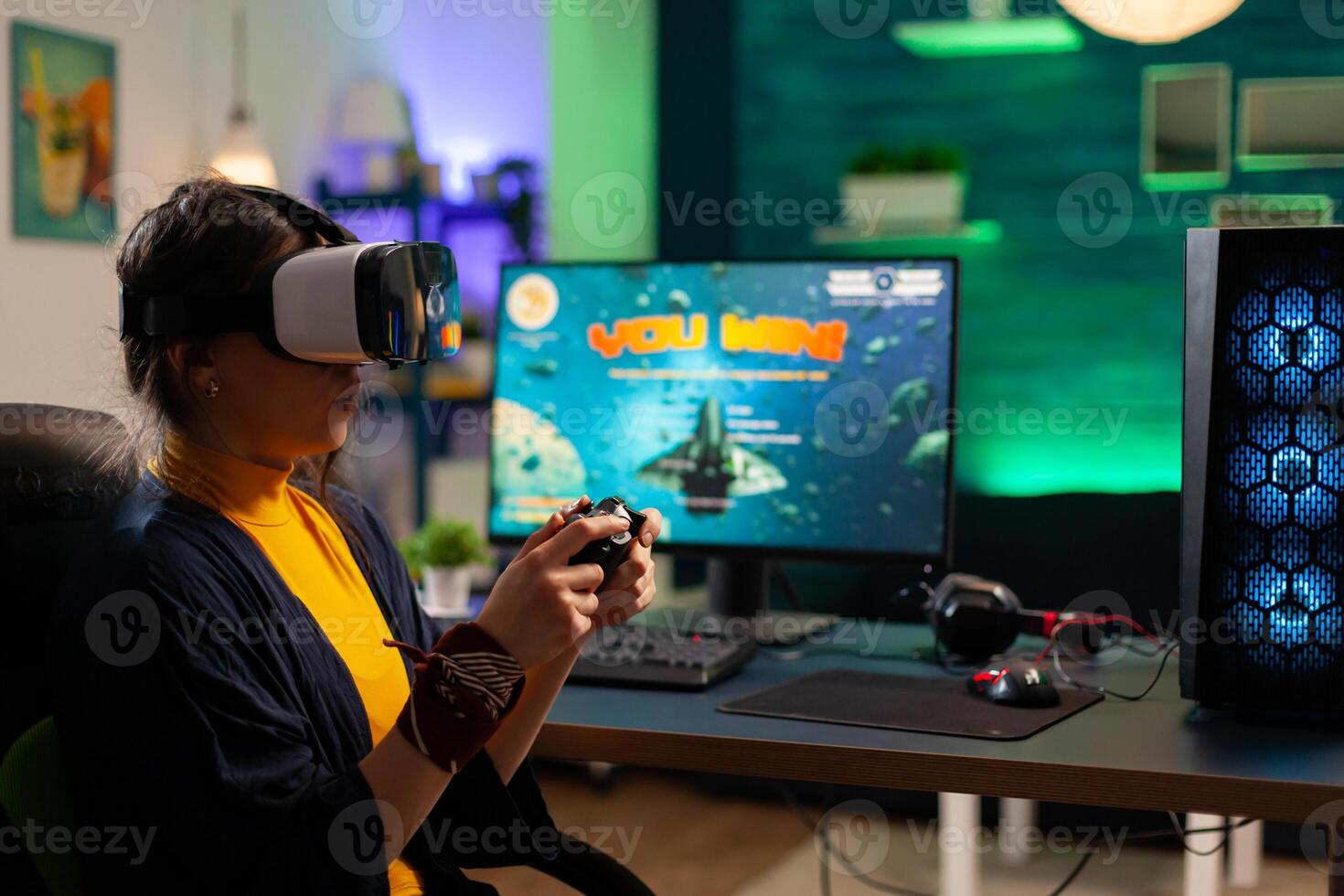Competitive gamer looking into powerful computer playing online shooter game late at night with vr headset and console wireless. Virtual online streaming cyber performing during game tournament photo