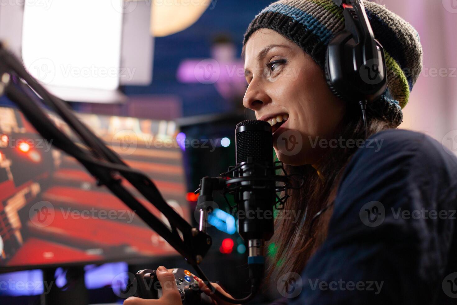 Close up of streamer woman talking into professional microphone in home studio. Online streaming cyber performing gaming tournament using technology network wireless photo