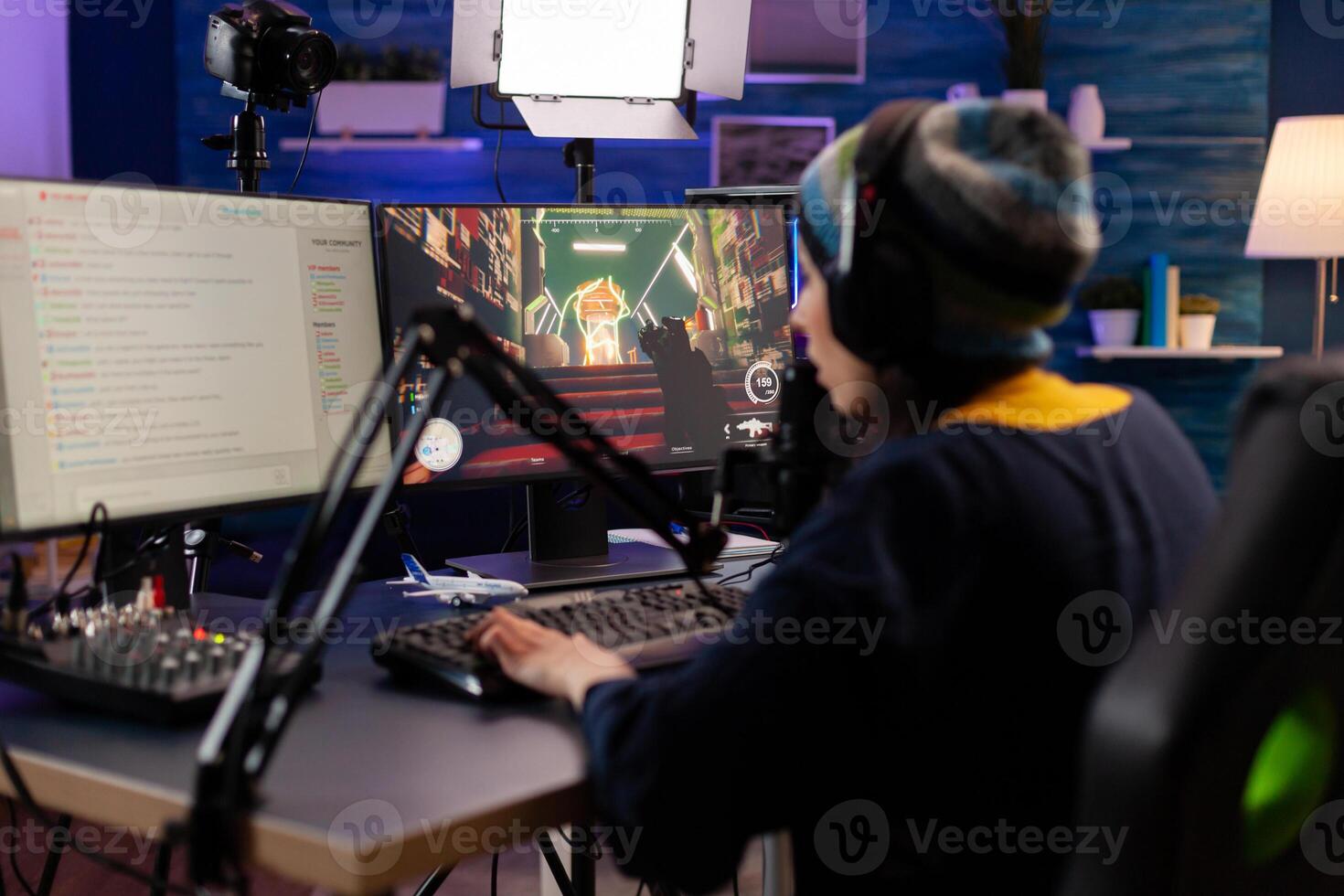 Esport streamer playing shooter game with other players on streaming chat for virtual games competition. Gamer making online videogames with new graphics on powerful computer photo