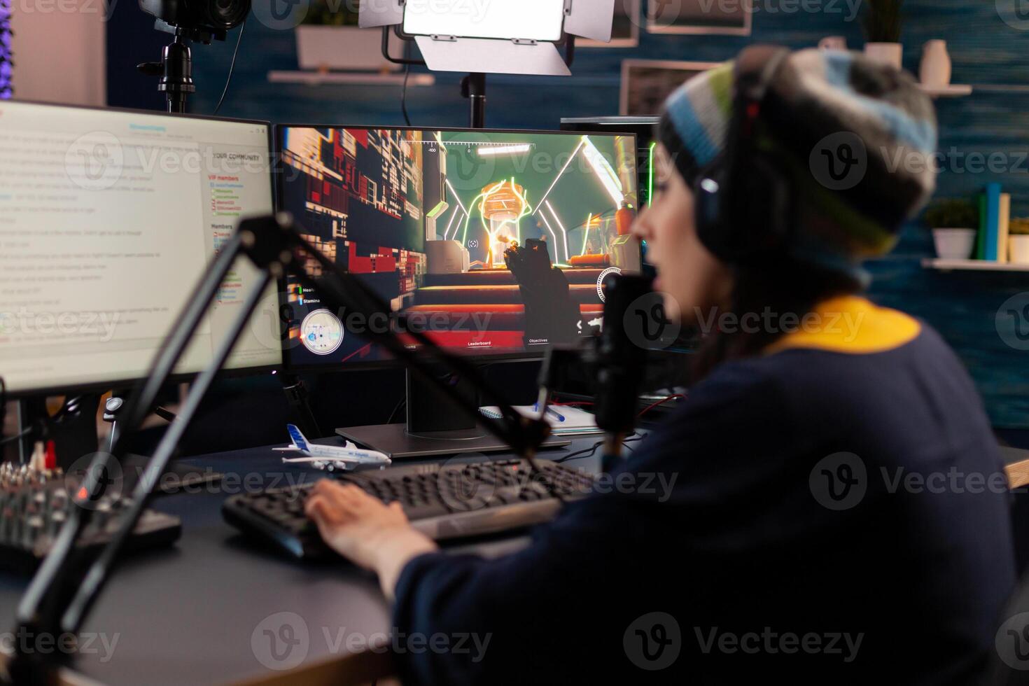 Pro streamer use headphones and looking into powerful monitor with gaming chat open. Online streaming cyber performing virtual tournament using technology network wireless photo