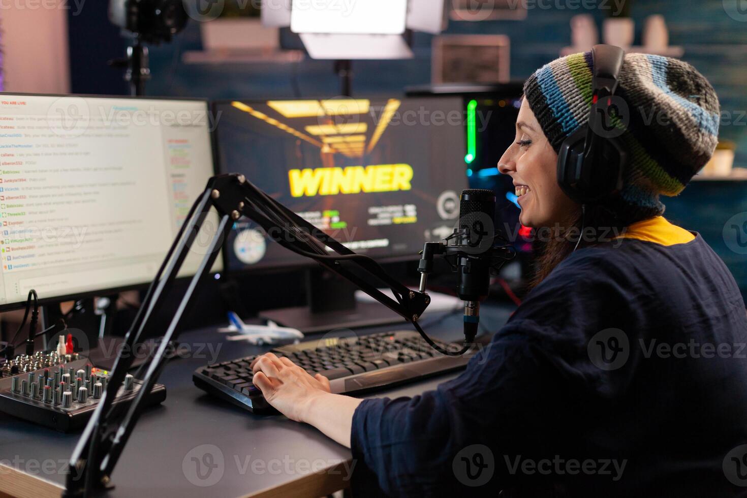 Game over for man streamer playing online shooter game using modern headseat and joystick. Cyber performing on powerful pc talking with players on chat open during professional competition photo