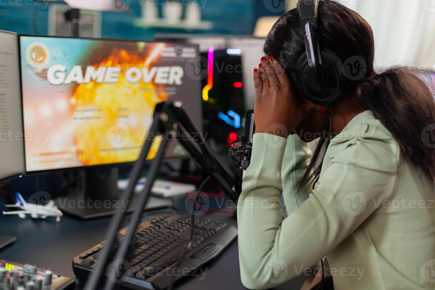 Disappointed african online game streamer losing championship, internet multiplayers. Professional gamer streaming online games with new graphics on powerful computer. photo