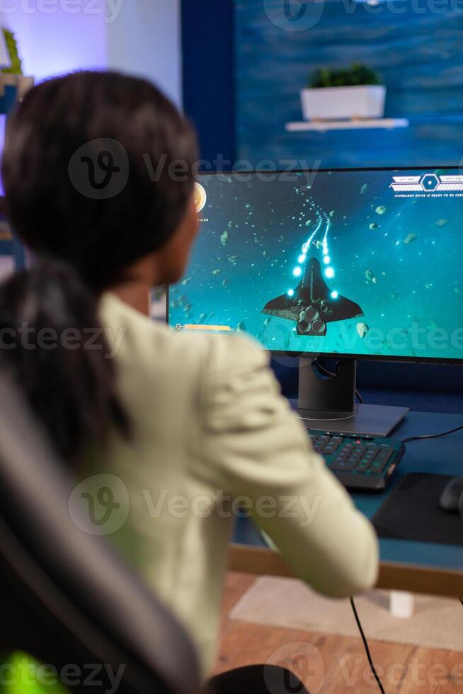 Professional esports gamer player during online championship with joystick. Competitive cyber player woman performing videogame tournament use professional joystick. photo