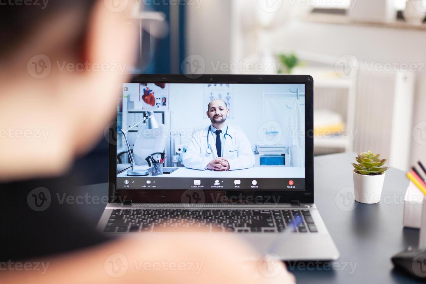 Student patient consulting therapist doctor having online videocall consultation during coronavirus quarantine. Young woman talking about medical treatment against disease while sitting in living room photo