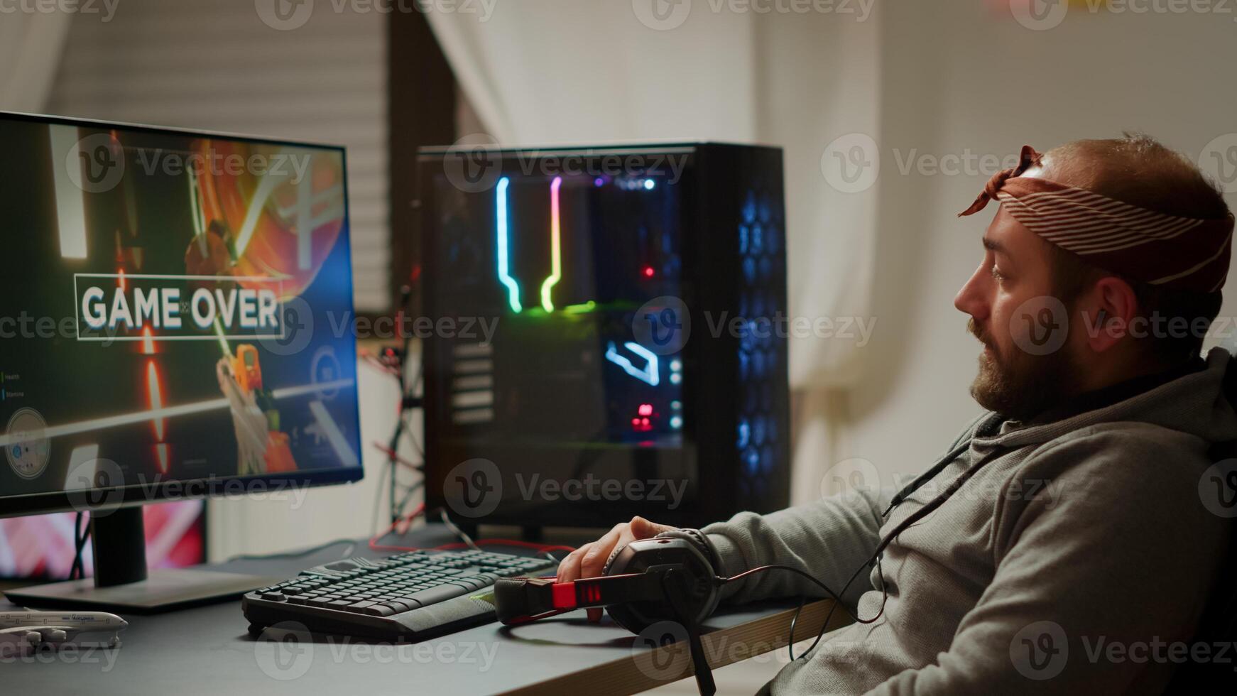 Angry pro gamer playing space shooter games and losing using RGB powerful computer. Gamer over of mock-up game player, performing in cyber room virtual game in cyberspace, gaming tournament photo