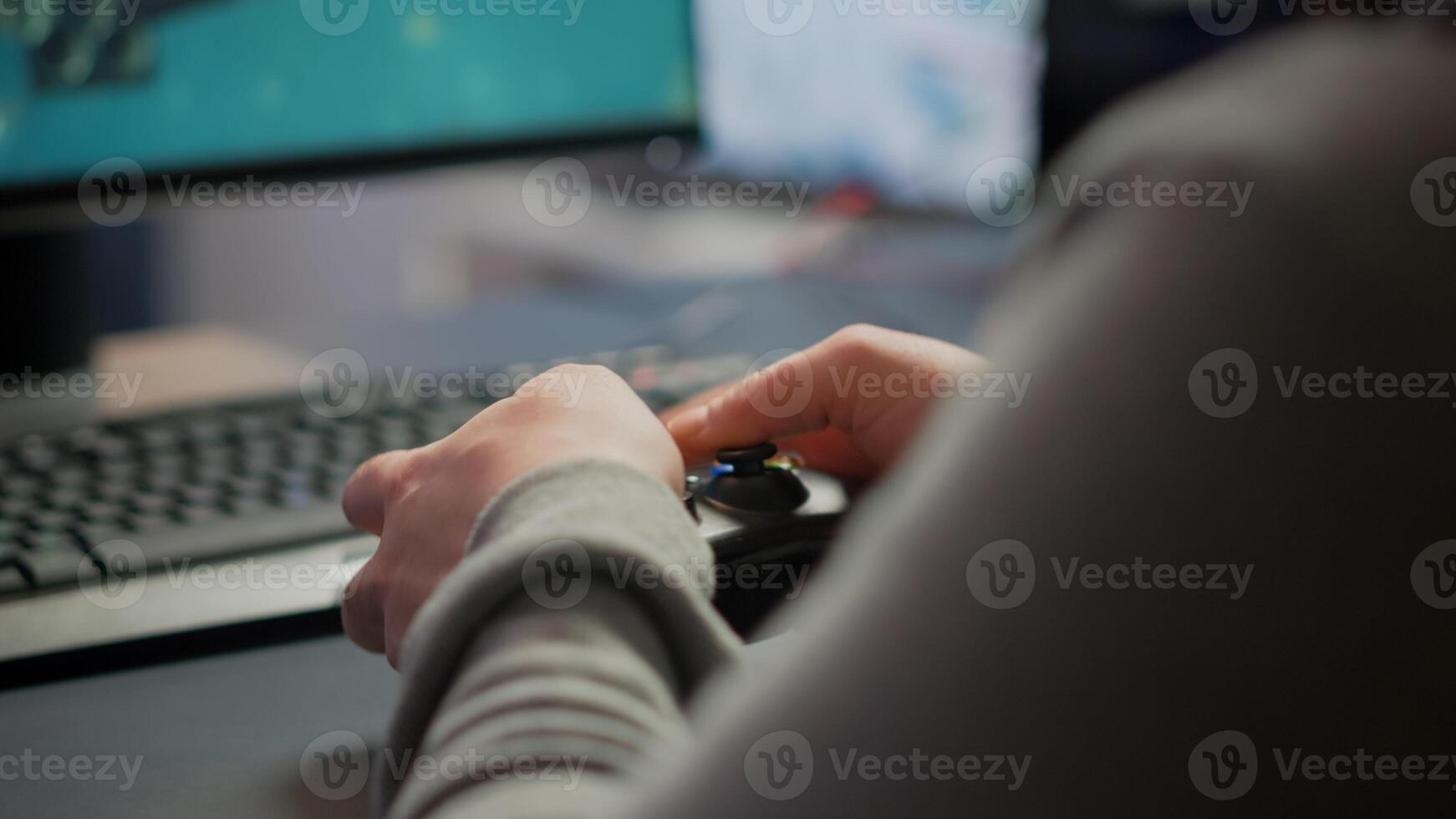 Close up on hands of game r playing using wireless joystick in cyberspace sitting on gaming chair. Cyber man holding controller performing space shooter games at online esports championship photo