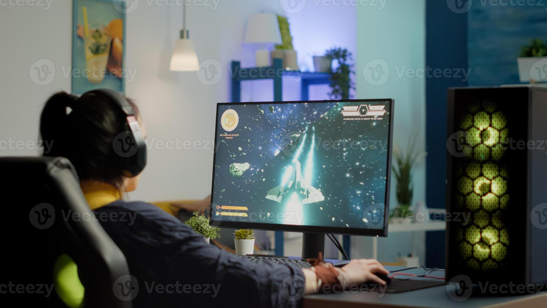 Concentrated woman gamer puting headset starting to play space shooter game on virtual competition on powerful personal computer. Esport cyber performing during esport gaming tournament photo