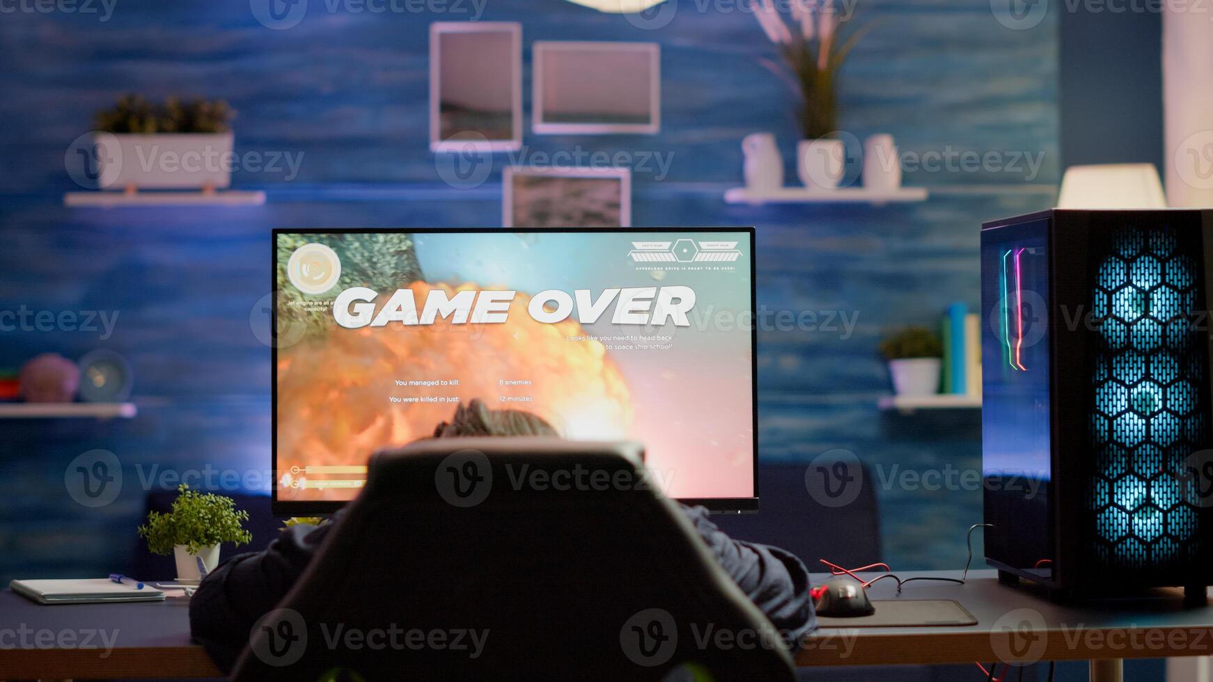 Upset professional woman gamer wearing headset losing space shooter game in cybersport competition. Tired pro cyber player gaming online games on powerful personal computer with RGB lights. photo