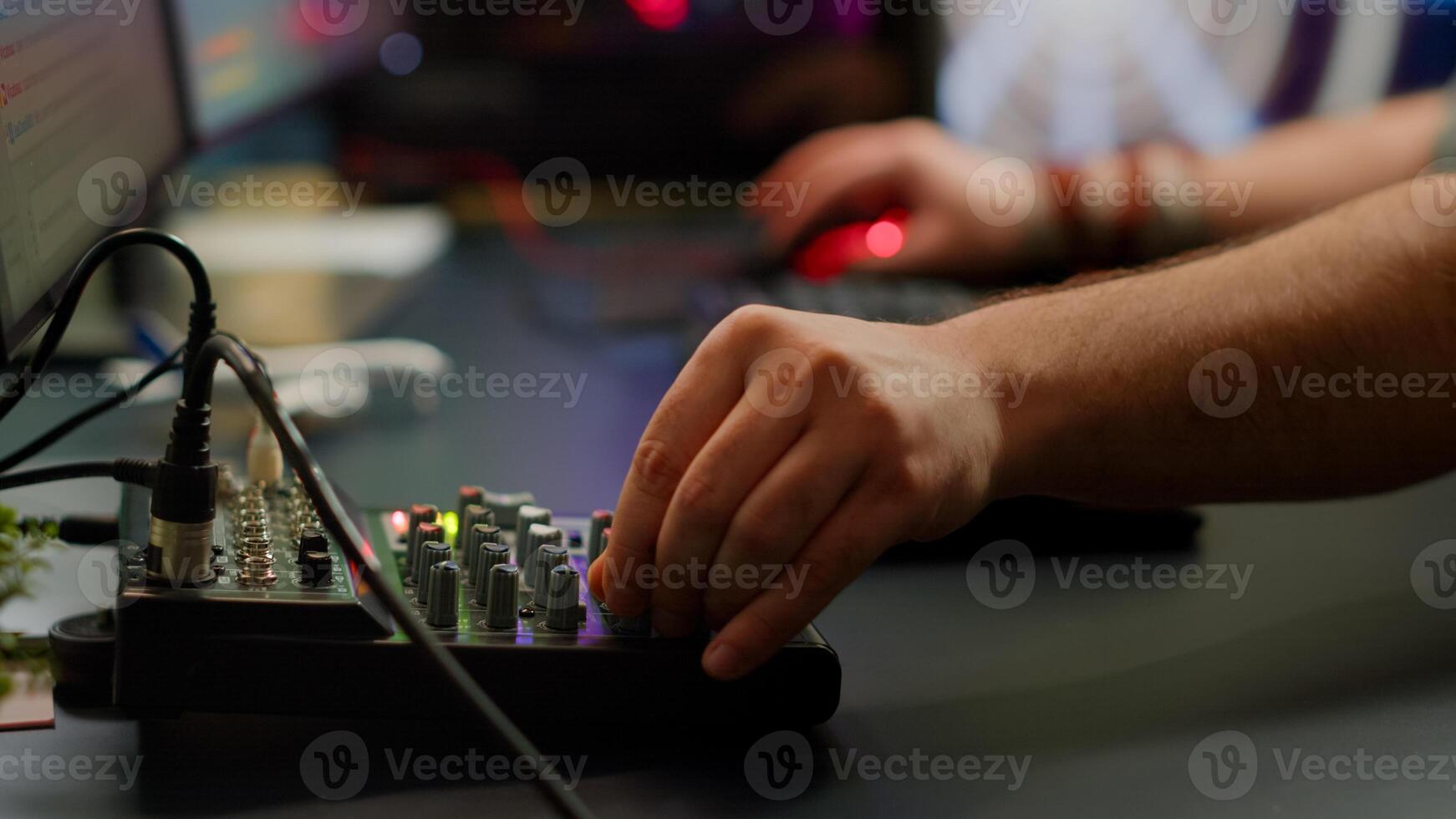 Close up of professional keyboard with RGB lighting streaming at chat. Player using powerful gaming computer in home studio of esport game typing at keypad playing space shooter videogame. photo