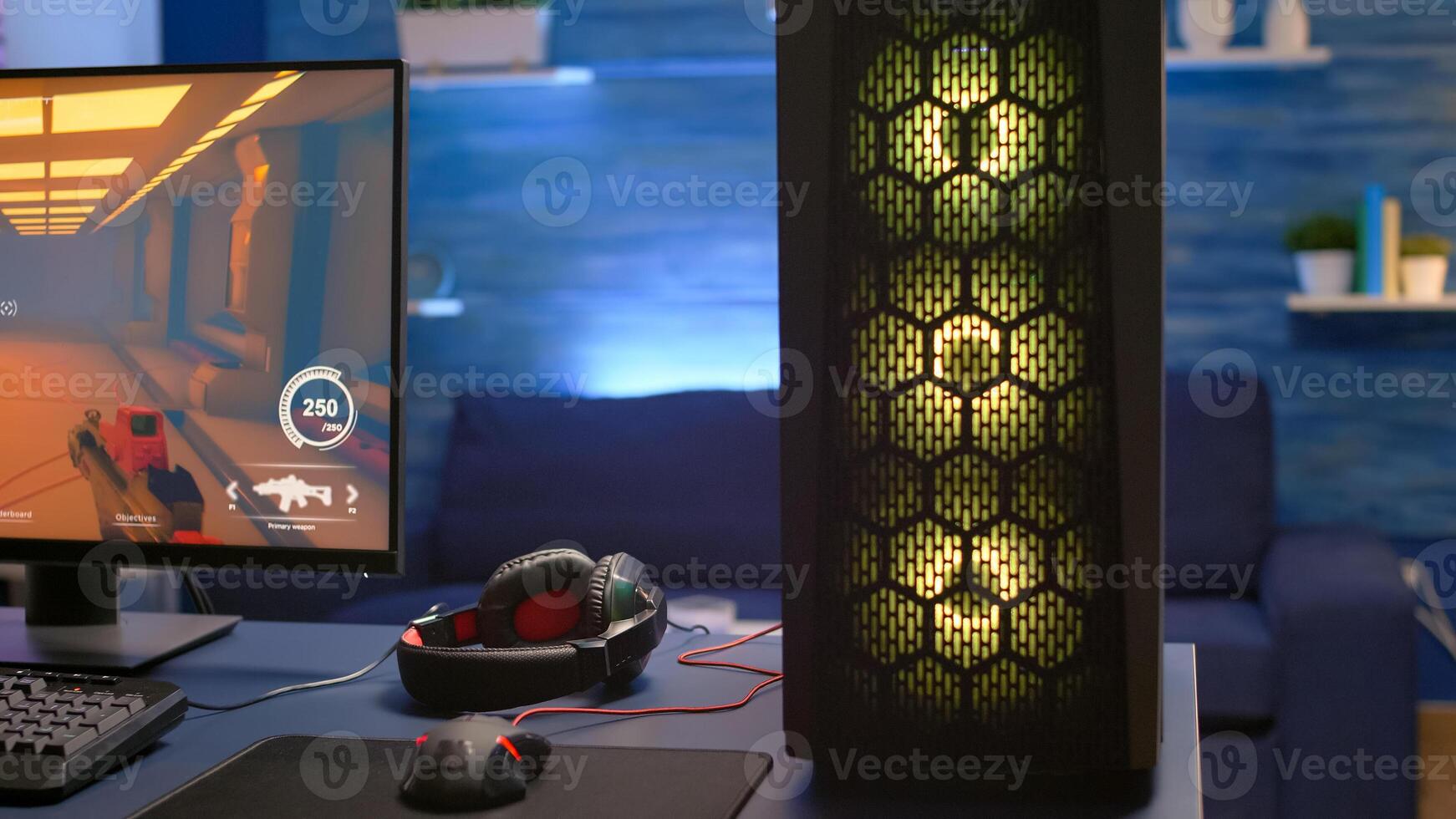 Close-up of RGB system desktop, pro gamer playing first person shooter game during online competition. Streaming studio is equipped with professional setup with powerful pc ready for online game photo