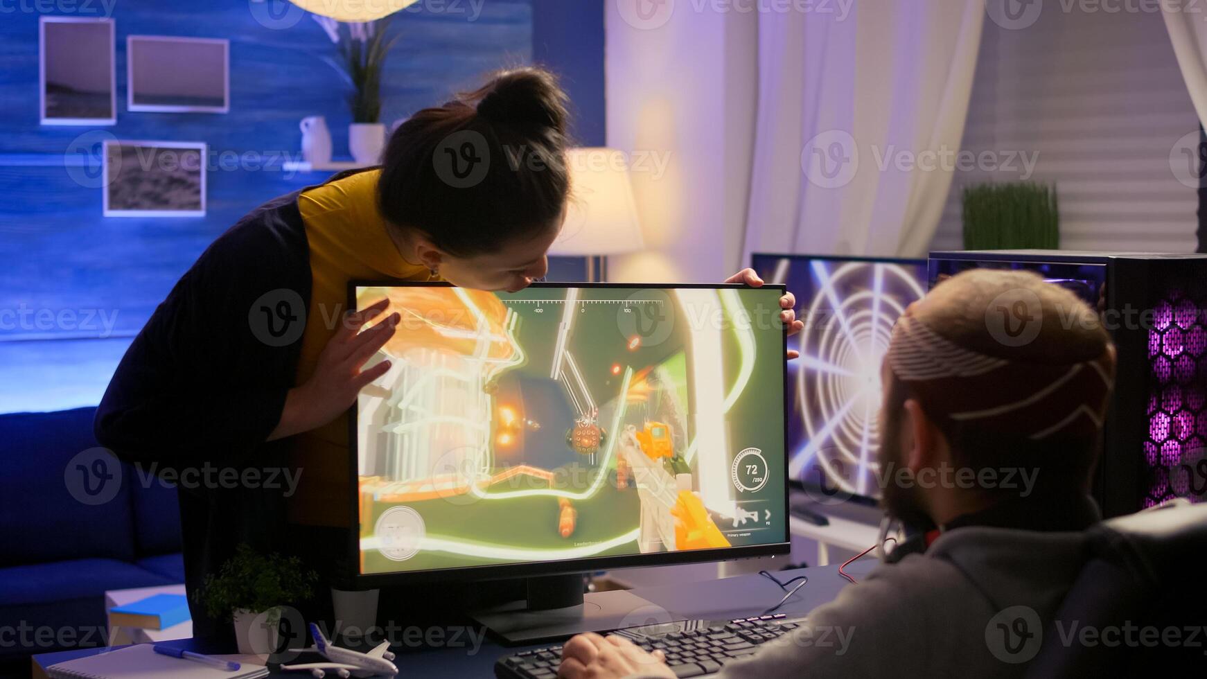 Cyber gamer fight with girlfriend about playing first person shooter game for online competition. Pro player performing on powerful pc in gaming room home during online tournament photo