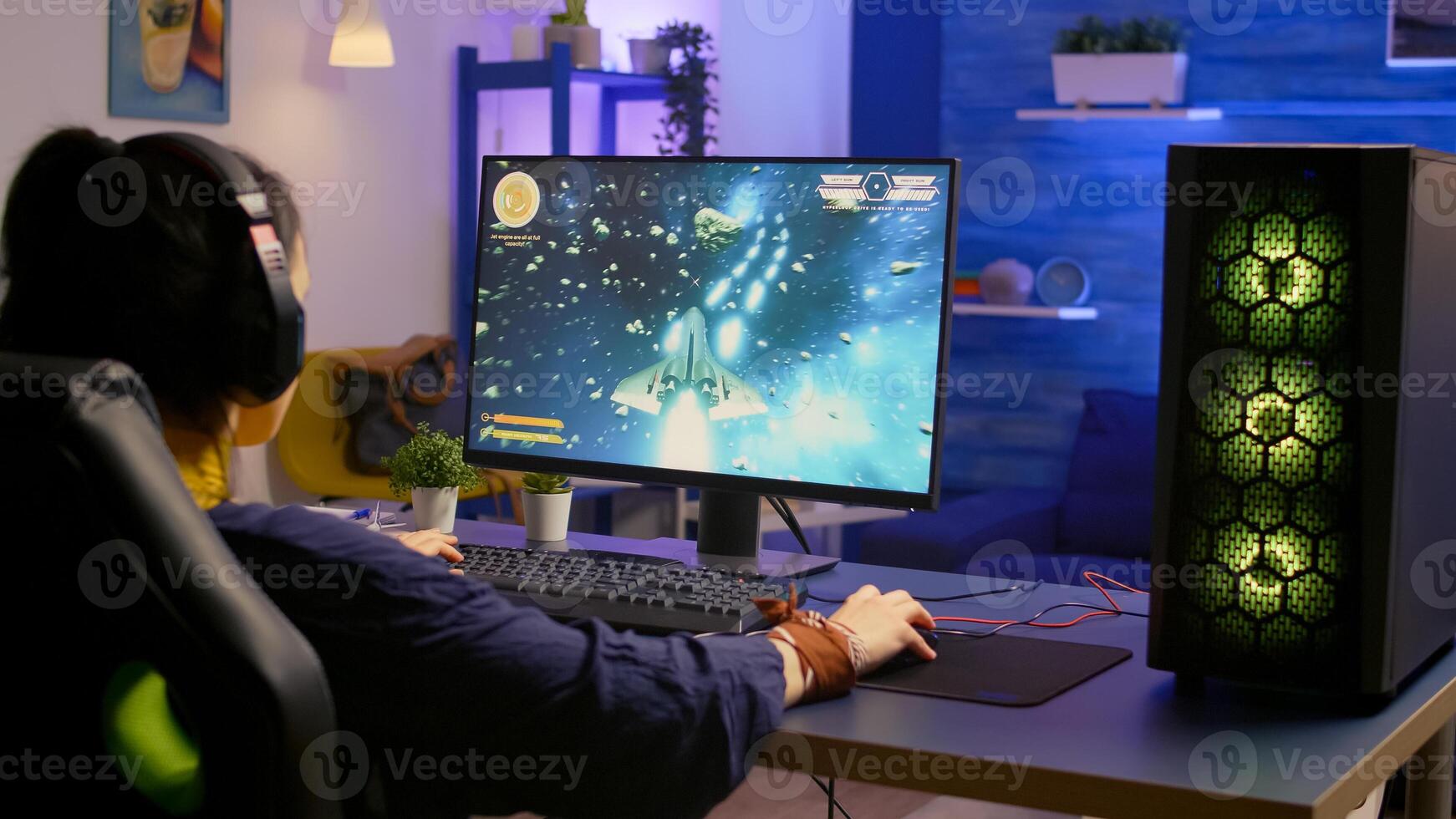 Gamer playing space shooter game on powerful computer using RGB gaming equipment. Pro player wearing headphones during digital esport tournament late at night at home studio. photo