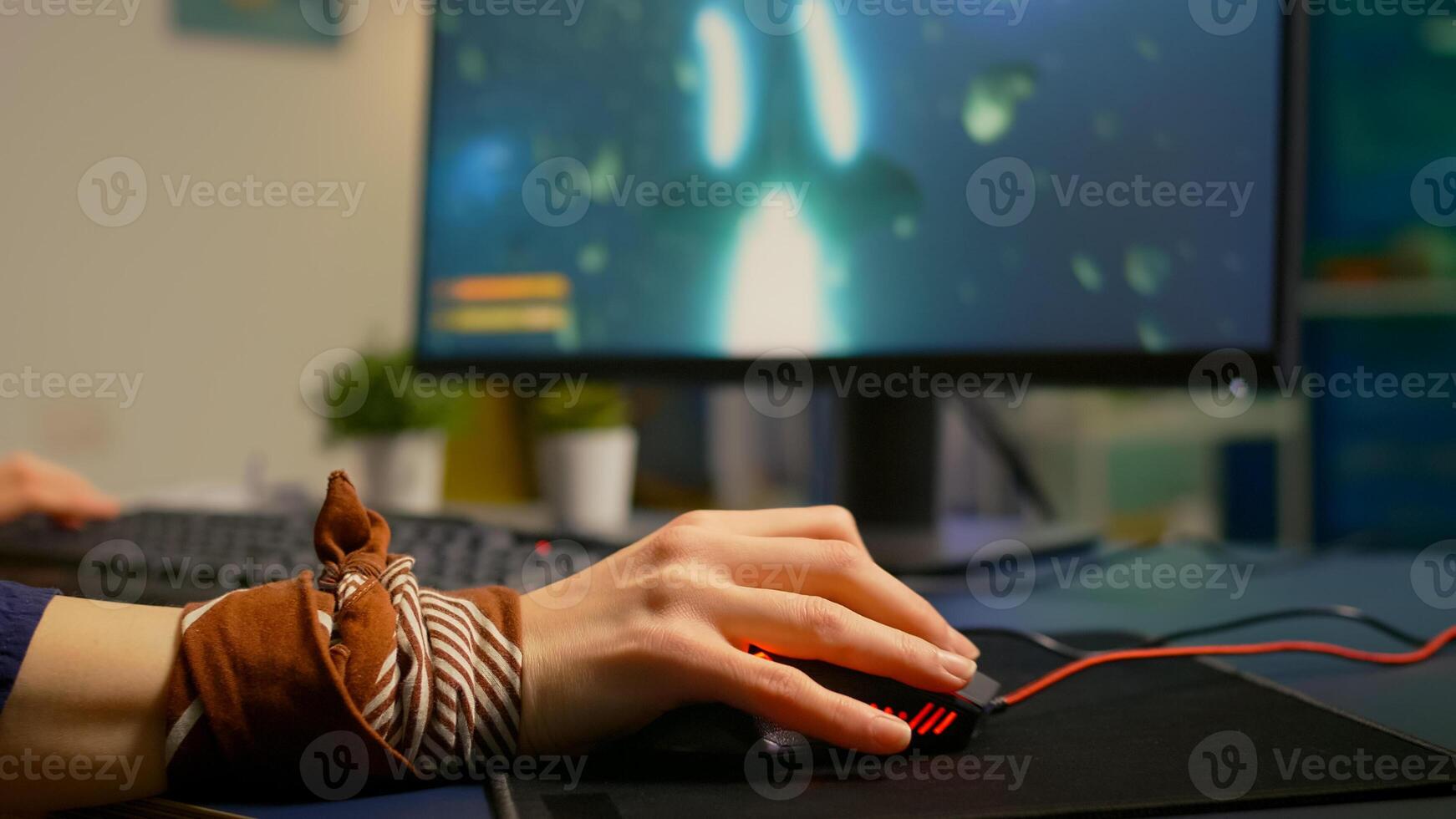 Close up of professional mouse in gaming home studio late at night. Pro gamer playing space shooter game using RGB powerful equipment for digital tournament photo