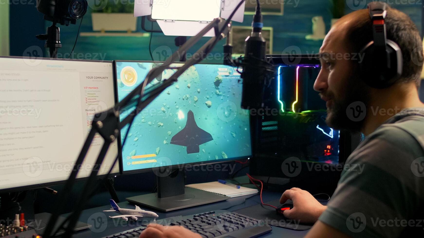 Pro streamer man playing space shooter games during online competition using professional setup with chat open. Gamer streaming games on professional powerful computer photo