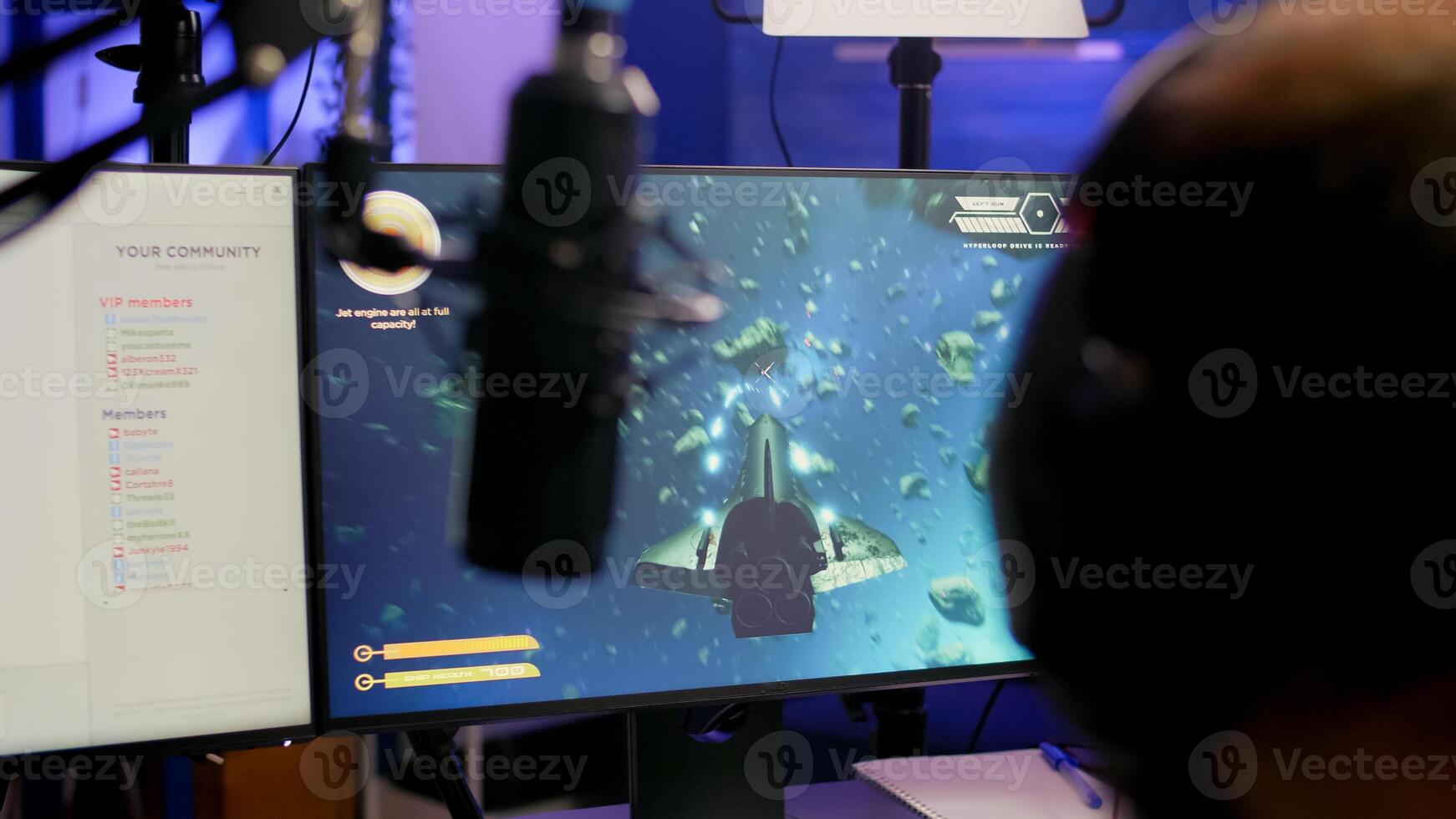 Game over for pro streamer playing online vide game space shooter in streaming room using modern headseat. Cyber performing on powerful pc talking with players on chat open during professional competition photo
