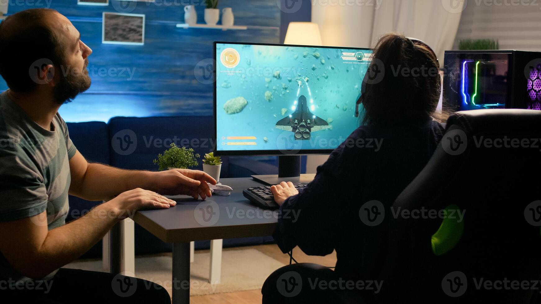 Pro gamer couple playing space shooter games sitting on gaming chiar wearing headphones. Professional digital player streaming game with modern graphics for online game championship photo