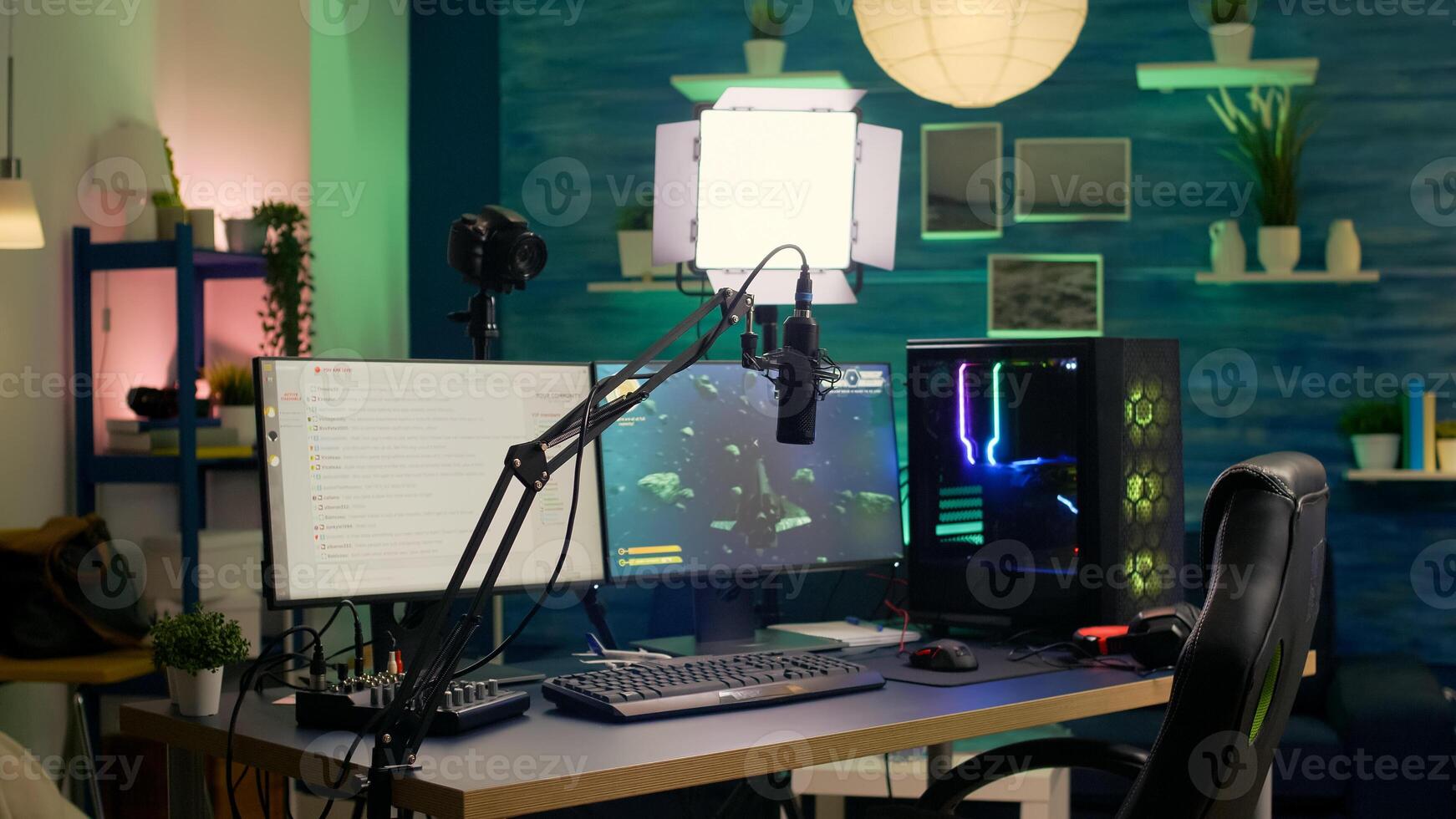 Empty streaming room with professional powerful computer, RGB keyboard and mouse, headphones and mirophone. Player talking with other players on streaming chat during online competition photo