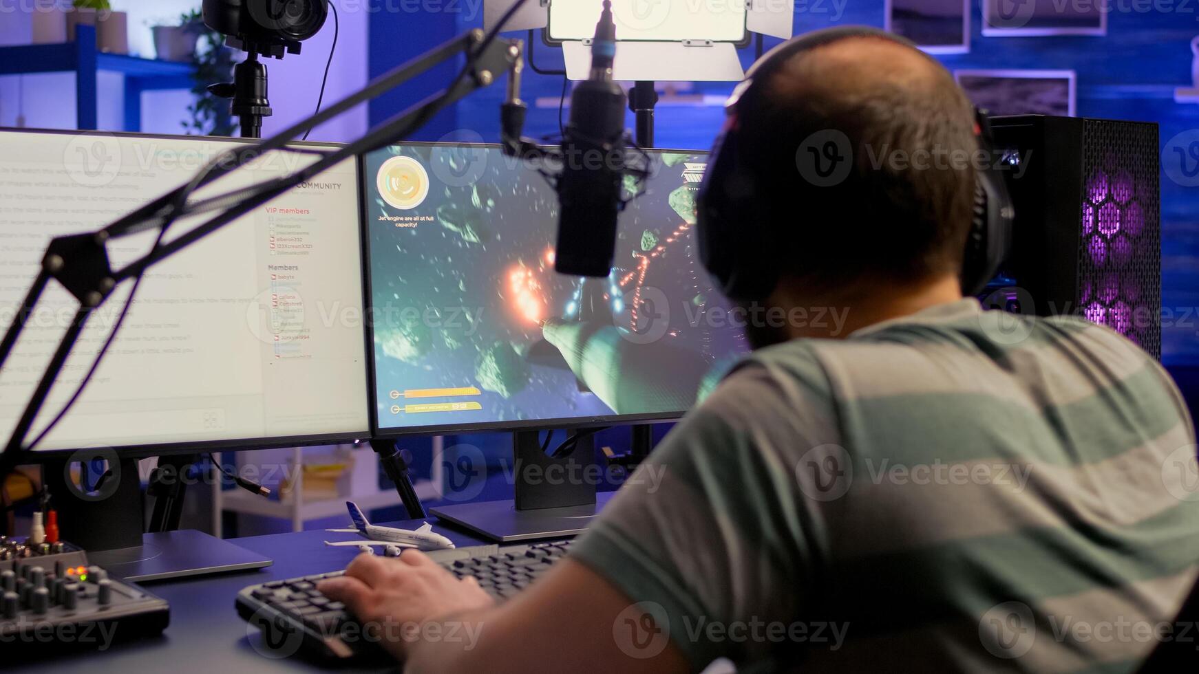 Streamer playing space shooter game , talking with other players about e-sport tournament. Winning for mock-up game r player, performing in streaming cyber studio, photo