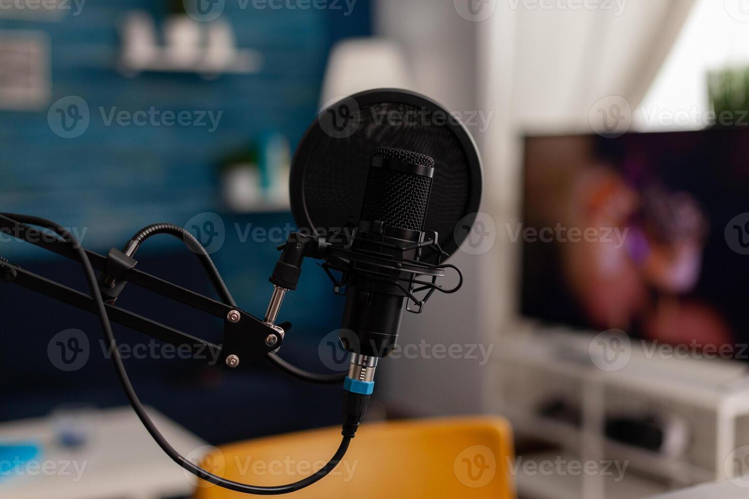 Closeup of recording microphone in home studio. Professional live broadcast equipment to record content on social media. Electronic audio livestream technology on desk. Podcast instrument. photo