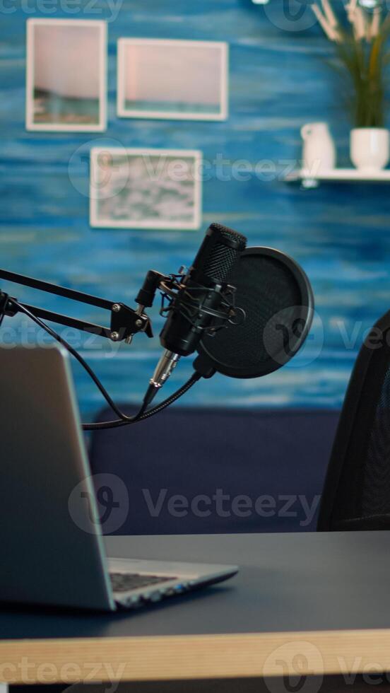 Empty podcast room with professional microphone in vlogger home studio in living. Influencer recording social media content with production microphone, digital web internet streaming station photo