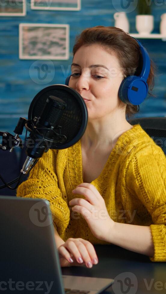 Famous blogger streaming from home studio putting headphones recording vlog. On-air online production internet broadcast show host streaming live content record digital social media communication photo