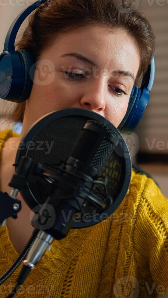 Creative blogger wearing headphones checking sound before talking with fans during live on social media, podcasting. On-air online production internet broadcast show host streaming live content photo